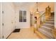 Elegant foyer showcasing hardwood floors, a staircase with wooden railing, and ample natural light at 9733 Camden Hills Ave, Las Vegas, NV 89145