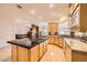 Spacious kitchen open to the Gathering room, featuring a center island with cooktop and custom cabinetry at 9733 Camden Hills Ave, Las Vegas, NV 89145