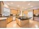 Well-lit kitchen with a large center island, modern appliances, wooden cabinetry and decorative backsplash at 9733 Camden Hills Ave, Las Vegas, NV 89145