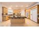 Open kitchen featuring a center island with cooktop, modern appliances, and generous cabinet space at 9733 Camden Hills Ave, Las Vegas, NV 89145