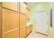 Spacious laundry area featuring light wood cabinetry for ample storage and a white door at 9733 Camden Hills Ave, Las Vegas, NV 89145