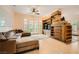 Bright living room with a comfy sectional sofa, built-in shelving, and french doors to the backyard at 9733 Camden Hills Ave, Las Vegas, NV 89145