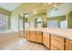 Main bathroom with dual sinks, mirrors, tiled floors, and a separate shower and bathtub at 9733 Camden Hills Ave, Las Vegas, NV 89145