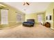 Spacious main bedroom with neutral carpet, large windows, and a comfortable bed, creating a serene atmosphere at 9733 Camden Hills Ave, Las Vegas, NV 89145