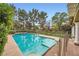 Inviting backyard swimming pool, bordered by a security fence and mature trees for privacy at 9733 Camden Hills Ave, Las Vegas, NV 89145