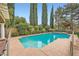 Beautiful swimming pool surrounded by lush landscaping, offering a serene backyard retreat at 9733 Camden Hills Ave, Las Vegas, NV 89145