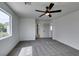 Carpeted bedroom showcasing ceiling fan, and doorway to bathroom at 9855 Ashton Pines Ct, Las Vegas, NV 89147