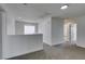 Upstairs landing space with neutral carpet, white walls, and recessed lighting at 9855 Ashton Pines Ct, Las Vegas, NV 89147