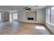 Spacious living room with wood flooring, a cozy fireplace, and lots of natural light from the windows at 9855 Ashton Pines Ct, Las Vegas, NV 89147