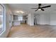 Open living room with wood floors, kitchen and stairs with plush carpet, and lots of natural light at 9855 Ashton Pines Ct, Las Vegas, NV 89147