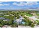 Expansive aerial view of a luxury home featuring a pool, surrounded by a golf course and mountain backdrop at 1108 Pine Island Ct, Las Vegas, NV 89134