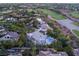Aerial view of a luxury home featuring a private pool, nestled in lush landscaping, with a golf course nearby at 1108 Pine Island Ct, Las Vegas, NV 89134