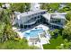 Aerial view showcases a modern home with a multi-section pool, patio, and lush landscaping at 1108 Pine Island Ct, Las Vegas, NV 89134