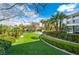 Spacious backyard featuring green grass, well-maintained landscaping, and palm trees, offering a serene retreat at 1108 Pine Island Ct, Las Vegas, NV 89134