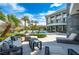 Stunning backyard oasis featuring a modern home, lush landscaping, inviting pool, and relaxing outdoor seating at 1108 Pine Island Ct, Las Vegas, NV 89134