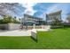 Expansive backyard with modern architecture, lush landscaping, and comfortable outdoor seating areas at 1108 Pine Island Ct, Las Vegas, NV 89134