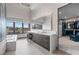 Modern bathroom with soaking tub, large vanity, mountain views, and closet access at 1108 Pine Island Ct, Las Vegas, NV 89134