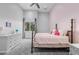 Charming bedroom featuring a metal bed frame, soft pink walls, and ample natural light at 1108 Pine Island Ct, Las Vegas, NV 89134