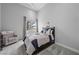 Cozy bedroom with a comfy armchair and stylish bedding at 1108 Pine Island Ct, Las Vegas, NV 89134