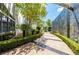 Serene walkway to a modern home, featuring lush landscaping, stone walls, and a welcoming entrance at 1108 Pine Island Ct, Las Vegas, NV 89134