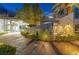 Beautifully landscaped entrance to a modern home, featuring stone accents and inviting outdoor seating at 1108 Pine Island Ct, Las Vegas, NV 89134