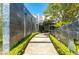 Inviting stone-lined walkway leading to a modern home's entrance, framed by manicured greenery and clean lines at 1108 Pine Island Ct, Las Vegas, NV 89134