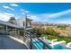 Stunning home with a private balcony overlooking a pool, lush landscaping, and mountain views at 1108 Pine Island Ct, Las Vegas, NV 89134