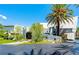 Striking modern home with unique architectural design, lush landscaping, and a towering palm tree at 1108 Pine Island Ct, Las Vegas, NV 89134