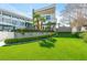 Manicured front lawn with lush green grass, neatly trimmed hedges, palm trees, and a modern home at 1108 Pine Island Ct, Las Vegas, NV 89134
