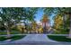 Beautiful home exterior featuring a manicured lawn, mature trees, and an elegant driveway at 1108 Pine Island Ct, Las Vegas, NV 89134