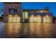 Well-lit three car garage showcasing a modern home's contemporary design and spacious driveway at 1108 Pine Island Ct, Las Vegas, NV 89134