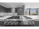 Modern kitchen with stainless steel appliances and a cooktop island at 1108 Pine Island Ct, Las Vegas, NV 89134