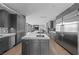 Sleek kitchen with stainless steel appliances, an island with a cooktop, and plenty of cabinet space at 1108 Pine Island Ct, Las Vegas, NV 89134