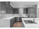 Modern kitchen with stainless steel appliances, grey cabinetry, and a stylish backsplash at 1108 Pine Island Ct, Las Vegas, NV 89134