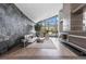 Bright living room with floor-to-ceiling windows, modern furnishings, and views of the pool at 1108 Pine Island Ct, Las Vegas, NV 89134