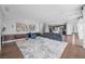Bright, open living room with wood floors, area rug, modern furniture, and recessed lighting at 1108 Pine Island Ct, Las Vegas, NV 89134