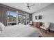 Bright main bedroom showcasing a ceiling fan, outdoor views, and stylish decor at 1108 Pine Island Ct, Las Vegas, NV 89134