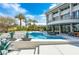 Gorgeous pool area with modern design, palm trees, and ample space for outdoor entertaining at 1108 Pine Island Ct, Las Vegas, NV 89134