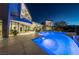 Night view of a luxurious pool with illuminated water and modern architectural design at 1108 Pine Island Ct, Las Vegas, NV 89134