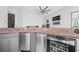 A stylish wet bar features stainless steel appliances and a granite countertop at 1108 Pine Island Ct, Las Vegas, NV 89134