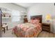Bedroom features wood floors, custom shelves, and a large window offering lots of natural light at 1174 King Lark St, Henderson, NV 89011
