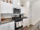Bright kitchen featuring stainless steel appliances, granite countertops, and crisp white cabinetry at 1174 King Lark St, Henderson, NV 89011