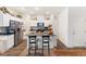 Bright kitchen featuring a central island with bar seating, stainless appliances, and white cabinetry at 1174 King Lark St, Henderson, NV 89011