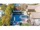 Aerial view of a luxurious swimming pool with a spa, surrounded by lush landscaping and outdoor seating areas at 12169 Castilla Rain Ave, Las Vegas, NV 89138