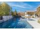 Beautiful backyard features a contemporary pool with spa and rock waterfall features surrounded by desert landscaping at 12169 Castilla Rain Ave, Las Vegas, NV 89138