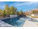 Gorgeous backyard showcases a modern pool and spa with waterfall features, creating a serene oasis at 12169 Castilla Rain Ave, Las Vegas, NV 89138