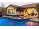 Inviting backyard with a sparkling pool, spa, and cozy outdoor seating area, ideal for evening gatherings at 12169 Castilla Rain Ave, Las Vegas, NV 89138