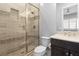 Modern bathroom featuring tiled shower with glass door and a sleek vanity at 12169 Castilla Rain Ave, Las Vegas, NV 89138