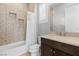 Well-lit bathroom with tiled shower, decorative wall tile, and modern vanity at 12169 Castilla Rain Ave, Las Vegas, NV 89138