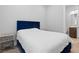 Bedroom featuring a queen bed with blue headboard, bedside table, and ensuite bathroom at 12169 Castilla Rain Ave, Las Vegas, NV 89138